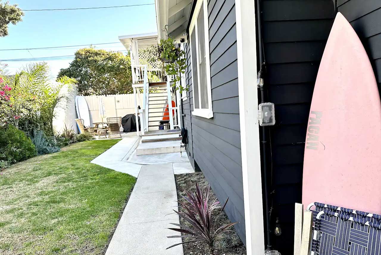 Pink Surf Board Leaning on Bungalow Wall
